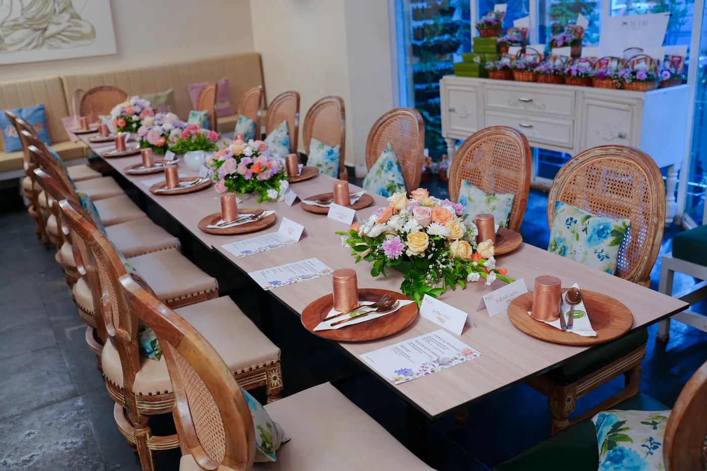 The table laid before an edition, places set and flowers arranged