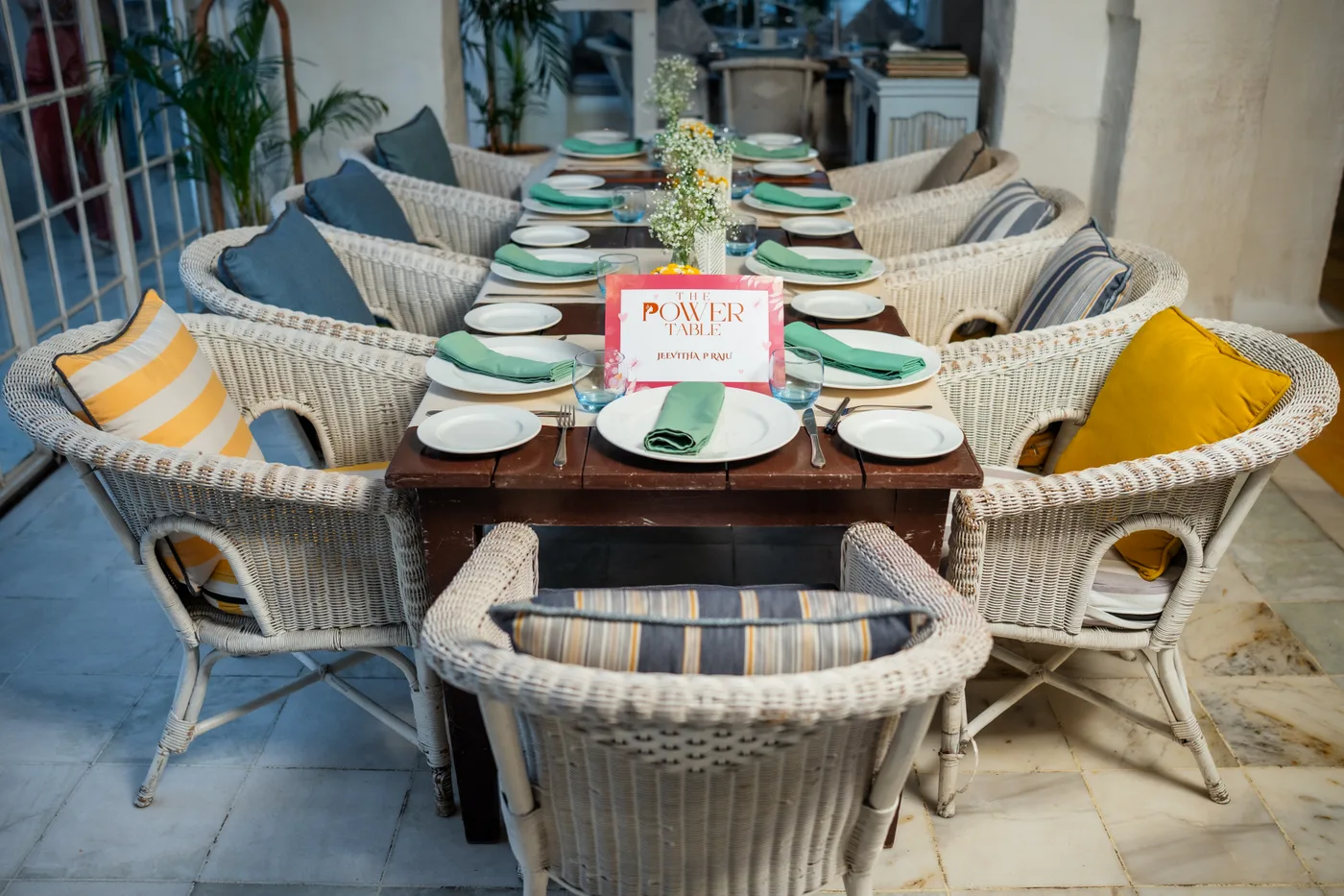 The Power Table card at the centre of a table set for guests