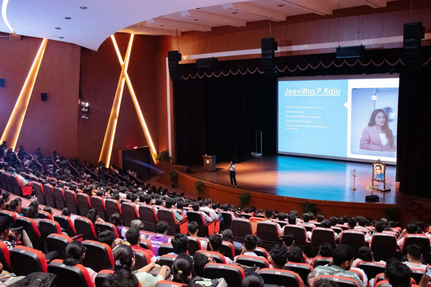 Jeevitha addressing a full auditorium on communication and growth